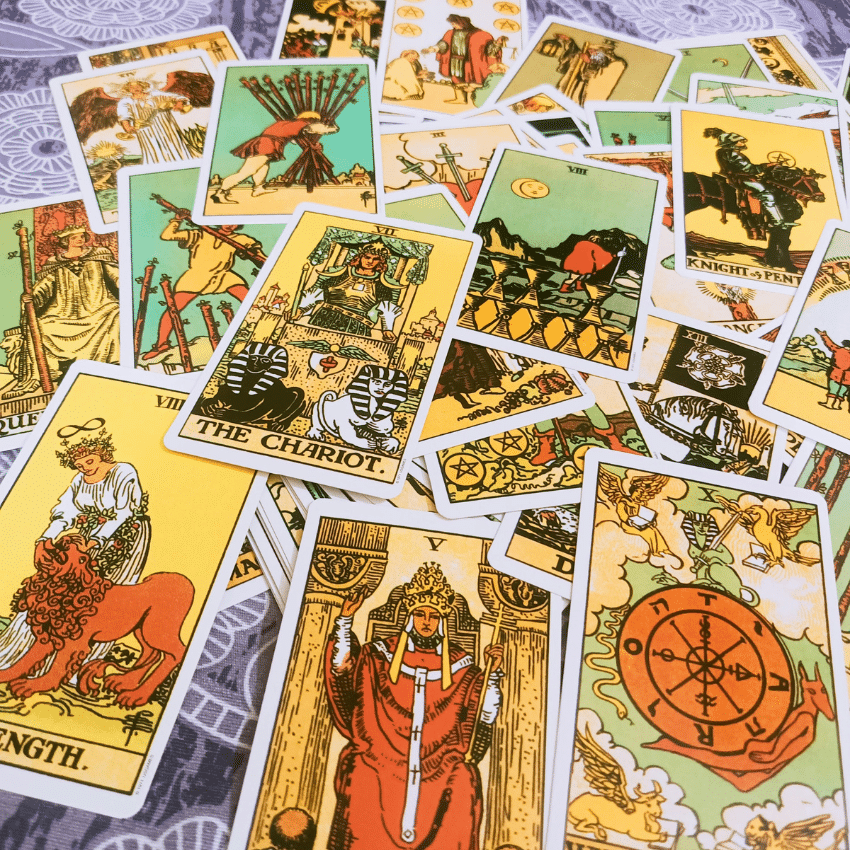 A spread of brightly colored Tarot cards to represent the energy of May Tarot horoscopes.